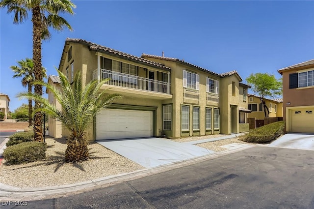 mediterranean / spanish-style home featuring a balcony, driveway, a tiled roof, and stucco siding