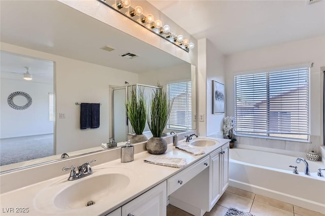 full bath featuring a bath, tile patterned flooring, a sink, and visible vents