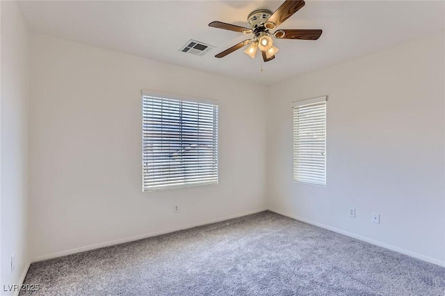 carpeted empty room with baseboards, visible vents, ceiling fan, and a healthy amount of sunlight