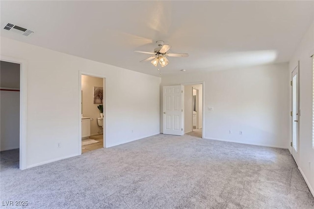 unfurnished bedroom with visible vents, baseboards, carpet floors, and a spacious closet
