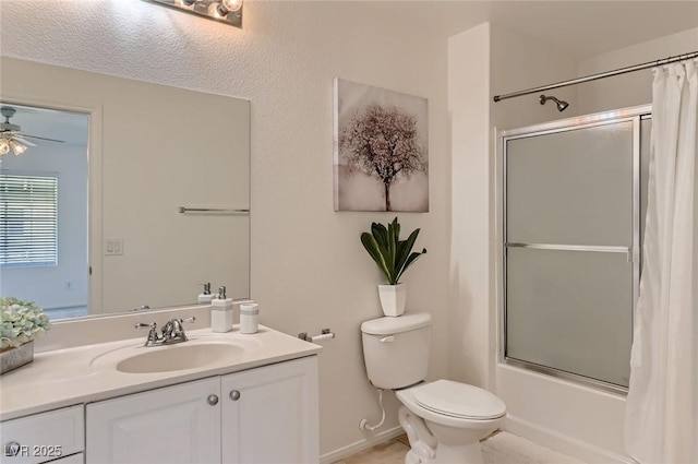 bathroom with vanity, shower / bath combo with shower curtain, ceiling fan, tile patterned floors, and toilet
