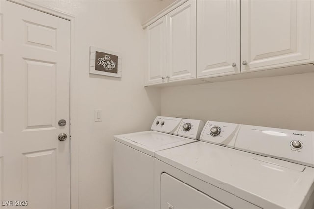 clothes washing area with washer and dryer and cabinet space