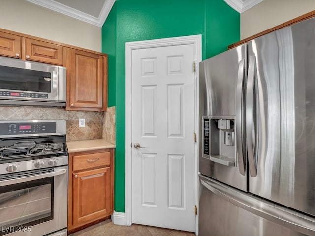 8728 Tom Noon Ave Unit 103, Las Vegas, NV 89178 - kitchen featuring stainless steel appliances, crown molding, backsplash, light countertops, and light tile patterned floors