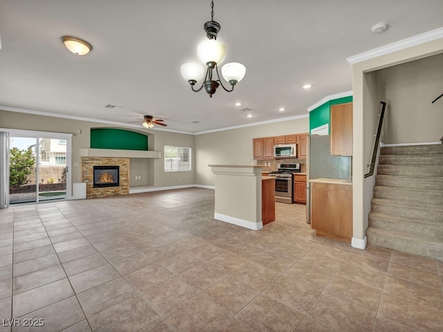 8728 Tom Noon Ave Unit 103, Las Vegas, NV 89178 - kitchen with light countertops, stainless steel appliances, baseboards, and ceiling fan with notable chandelier