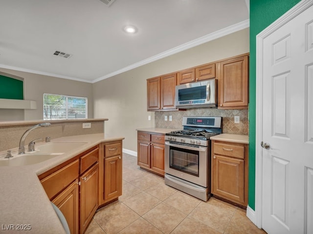 8728 Tom Noon Ave Unit 103, Las Vegas, NV 89178 - kitchen with crown molding, stainless steel appliances, visible vents, and a sink