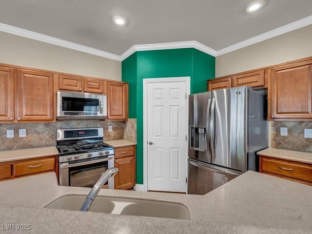 8728 Tom Noon Ave Unit 103, Las Vegas, NV 89178 - kitchen featuring crown molding, appliances with stainless steel finishes, light countertops, and a sink