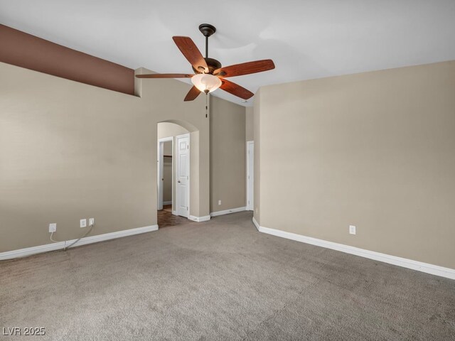 8728 Tom Noon Ave Unit 103, Las Vegas, NV 89178 - empty room with lofted ceiling, carpet floors, arched walkways, a ceiling fan, and baseboards