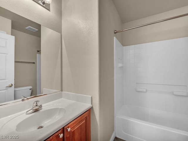 8728 Tom Noon Ave Unit 103, Las Vegas, NV 89178 - bathroom with toilet, visible vents, vanity, and shower / tub combination