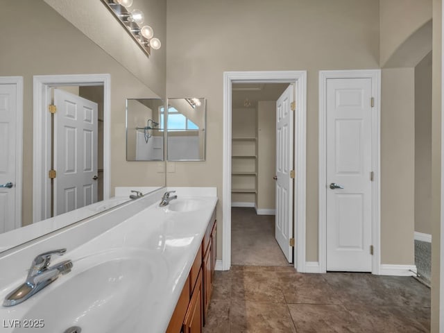 8728 Tom Noon Ave Unit 103, Las Vegas, NV 89178 - full bath featuring double vanity, a closet, baseboards, and a sink