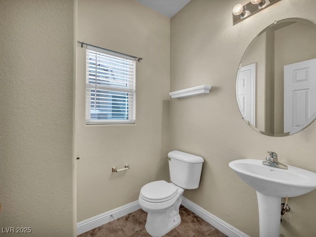 8728 Tom Noon Ave Unit 103, Las Vegas, NV 89178 - half bath with toilet, baseboards, tile patterned flooring, and a sink