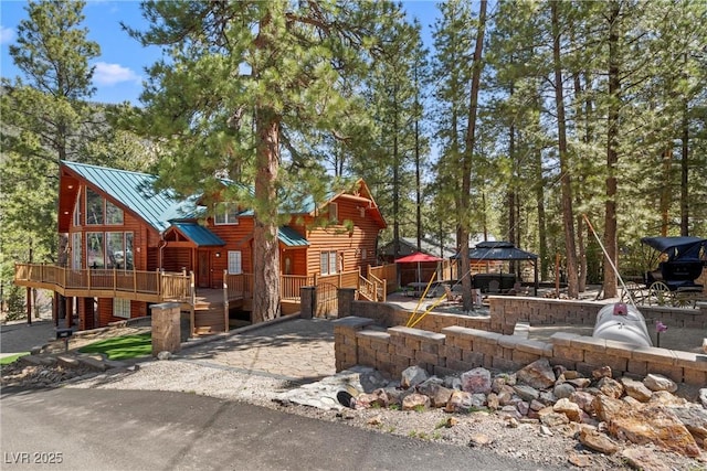 exterior space with a wooden deck and a gazebo