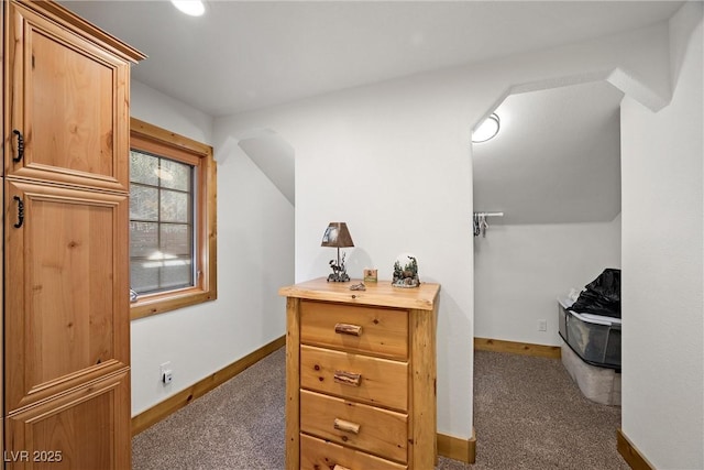interior space featuring carpet flooring and baseboards