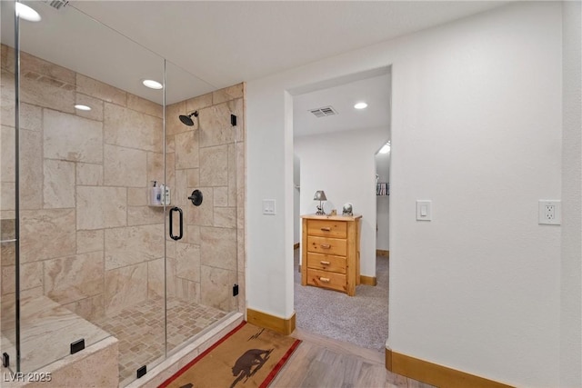 bathroom featuring visible vents, a shower stall, wood finished floors, baseboards, and recessed lighting