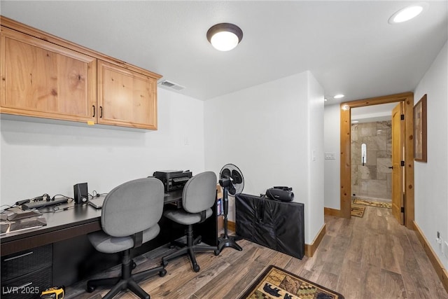 office featuring recessed lighting, baseboards, visible vents, and wood finished floors