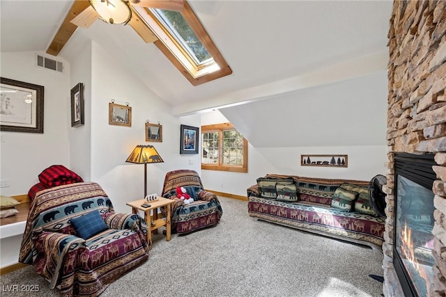 living room with carpet floors, ceiling fan, visible vents, and vaulted ceiling with skylight