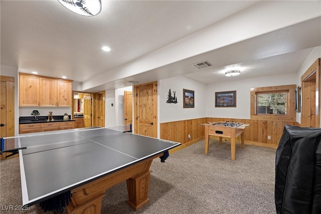 playroom with visible vents, carpet flooring, a wainscoted wall, and wooden walls