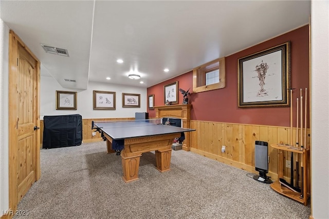 recreation room featuring visible vents, a fireplace, wainscoting, carpet, and recessed lighting