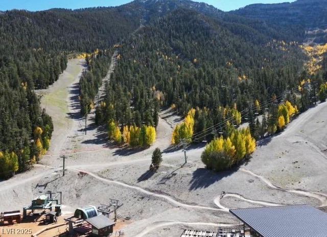 drone / aerial view with a mountain view and a wooded view