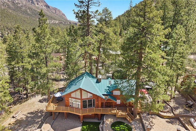 birds eye view of property with a mountain view and a wooded view