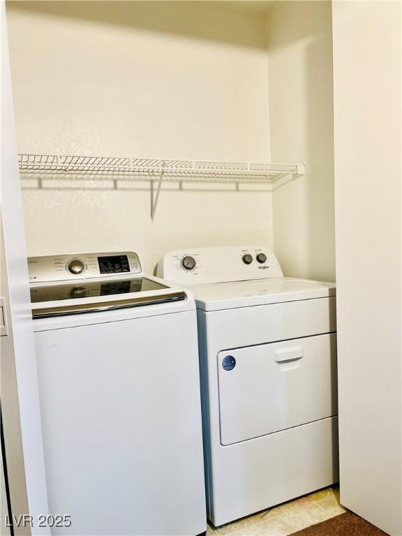 8101 W Flamingo Rd Unit 1088, Las Vegas, NV 89147 - clothes washing area with light tile patterned flooring, laundry area, and independent washer and dryer