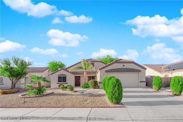 2514 Tropical Sands Ave, North Las Vegas, NV 89031 - mediterranean / spanish-style home with a garage, stucco siding, a tile roof, and concrete driveway