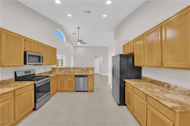 2514 Tropical Sands Ave, North Las Vegas, NV 89031 - kitchen with visible vents, a peninsula, ceiling fan, high vaulted ceiling, and appliances with stainless steel finishes