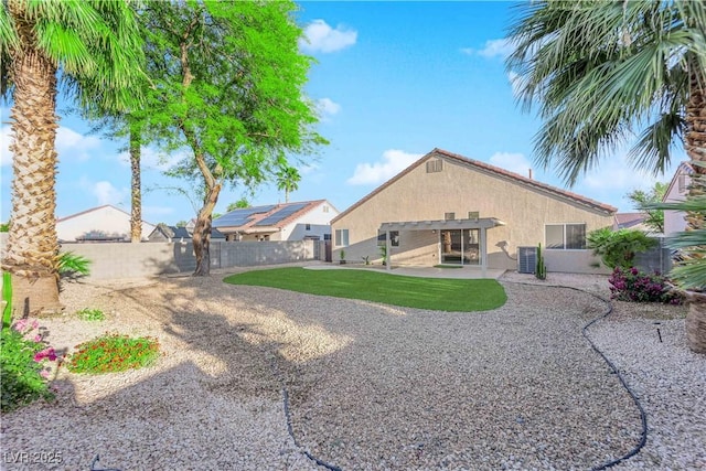 2514 Tropical Sands Ave, North Las Vegas, NV 89031 - rear view of property with stucco siding, a fenced backyard, cooling unit, a lawn, and a patio