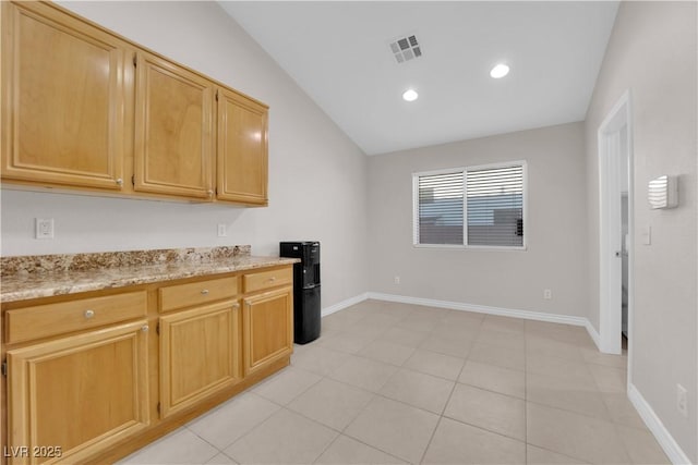 2514 Tropical Sands Ave, North Las Vegas, NV 89031 - kitchen featuring visible vents, vaulted ceiling, baseboards, light stone counters, and recessed lighting