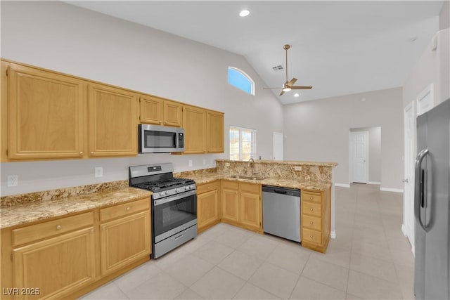 2514 Tropical Sands Ave, North Las Vegas, NV 89031 - kitchen with ceiling fan, a sink, high vaulted ceiling, stainless steel appliances, and a peninsula