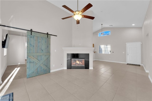 2514 Tropical Sands Ave, North Las Vegas, NV 89031 - unfurnished living room with ceiling fan, a barn door, a fireplace, high vaulted ceiling, and tile patterned floors