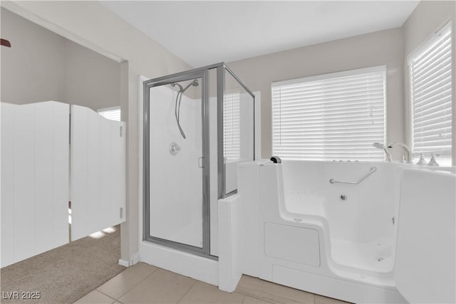 2514 Tropical Sands Ave, North Las Vegas, NV 89031 - bathroom with a bathing tub, tile patterned floors, and a stall shower