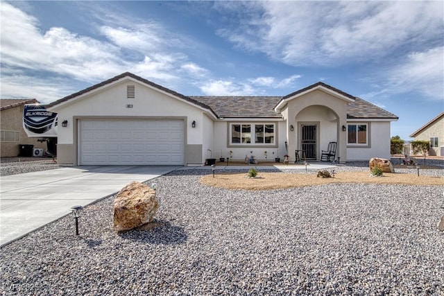 single story home featuring stucco siding, driveway, and an attached garage