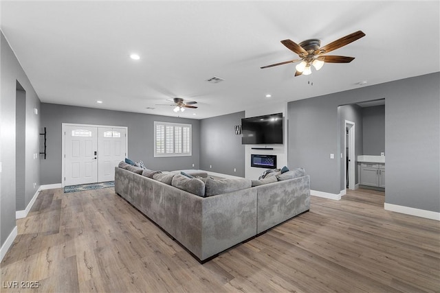 3660 Stirrup, Pahrump, NV 89048 - living area featuring baseboards, visible vents, a ceiling fan, and light wood finished floors