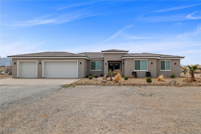 3660 Stirrup, Pahrump, NV 89048 - prairie-style house with driveway, stucco siding, and an attached garage