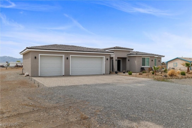 3660 Stirrup, Pahrump, NV 89048 - prairie-style house featuring a garage and stucco siding