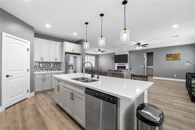 3660 Stirrup, Pahrump, NV 89048 - kitchen featuring light wood-style floors, appliances with stainless steel finishes, a sink, a ceiling fan, and open floor plan