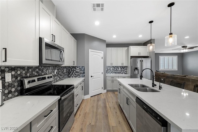 3660 Stirrup, Pahrump, NV 89048 - kitchen featuring a sink, appliances with stainless steel finishes, visible vents, light wood finished floors, and a ceiling fan