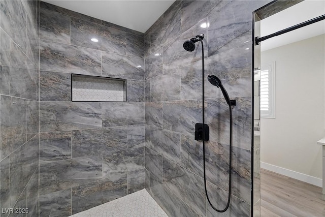 3660 Stirrup, Pahrump, NV 89048 - full bathroom featuring baseboards, tiled shower, and wood finished floors