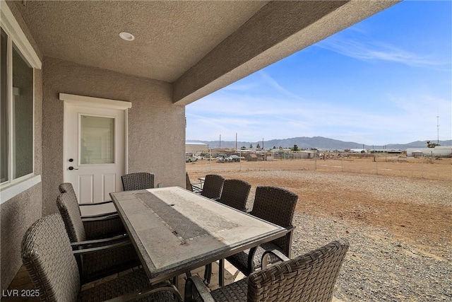 3660 Stirrup, Pahrump, NV 89048 - view of patio / terrace featuring fence, a mountain view, and outdoor dining area