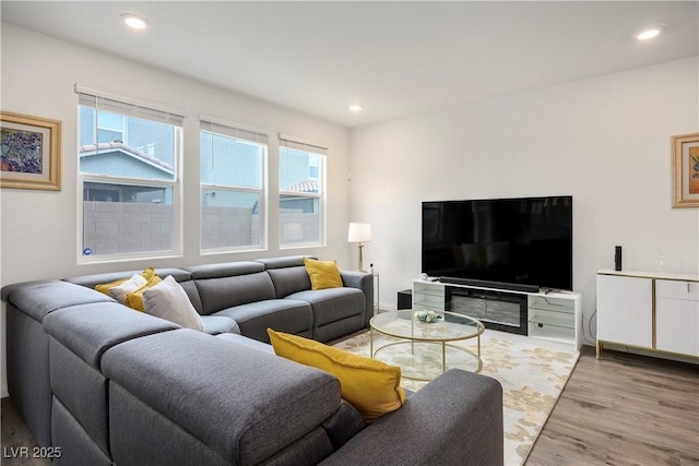 living room with baseboards, recessed lighting, and wood finished floors