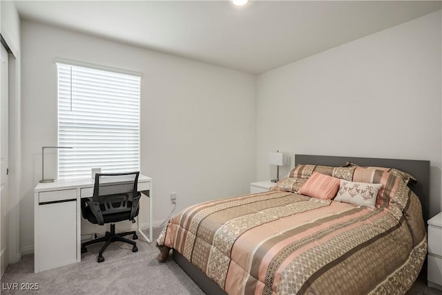 bedroom featuring baseboards and light carpet
