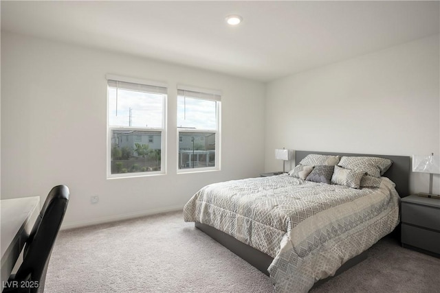 carpeted bedroom featuring recessed lighting and baseboards
