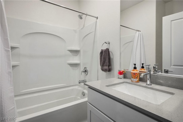 bathroom featuring shower / bath combo with shower curtain and vanity