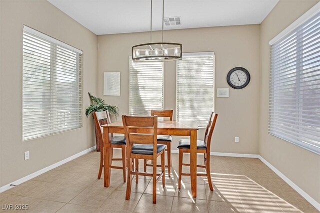 2132 Twin Falls Dr, Henderson, NV 89044 - dining space with a chandelier, light tile patterned floors, and baseboards