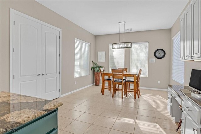 2132 Twin Falls Dr, Henderson, NV 89044 - dining room with healthy amount of natural light, baseboards, and light tile patterned floors