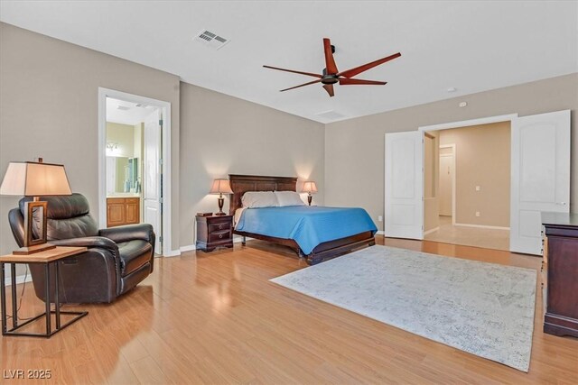 2132 Twin Falls Dr, Henderson, NV 89044 - bedroom featuring light wood-style floors, baseboards, ceiling fan, and ensuite bath