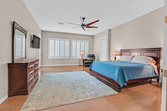 2132 Twin Falls Dr, Henderson, NV 89044 - bedroom with light wood-style flooring, baseboards, and a ceiling fan