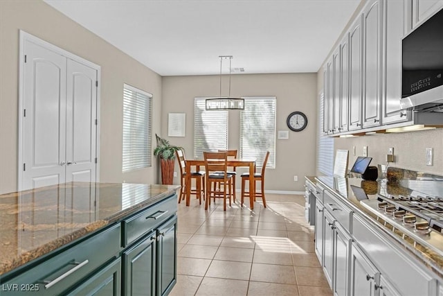 2132 Twin Falls Dr, Henderson, NV 89044 - kitchen with stainless steel appliances, healthy amount of natural light, green cabinetry, and baseboards