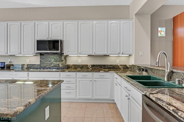 2132 Twin Falls Dr, Henderson, NV 89044 - kitchen featuring appliances with stainless steel finishes, a sink, dark stone countertops, and white cabinets