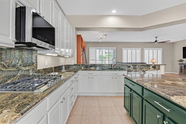 2132 Twin Falls Dr, Henderson, NV 89044 - kitchen featuring green cabinets, stainless steel appliances, a sink, white cabinets, and recessed lighting